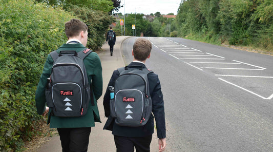 Two teens wearing Futliit LED backpacks