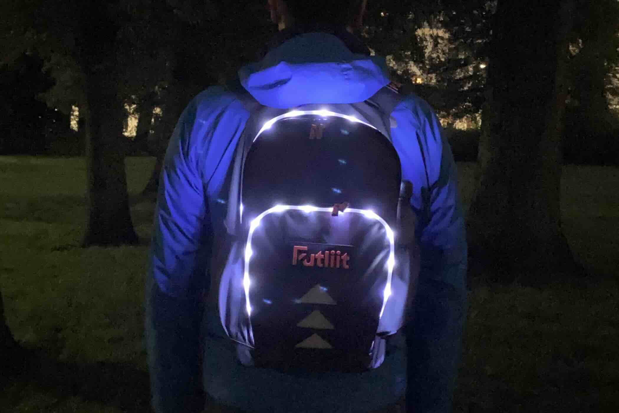 Commuter wearing a Futliit LED backpack in the dark