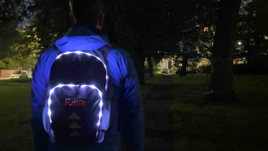 Man wearing Futliit LED backpack in a park in the dark