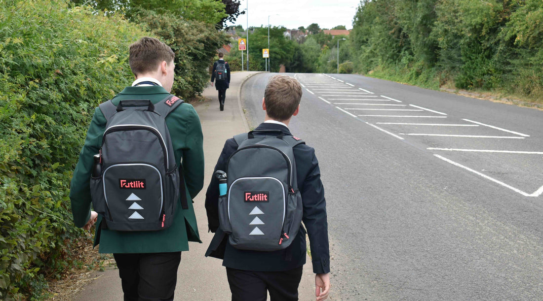 Two teens wearing Futliit LED backpacks